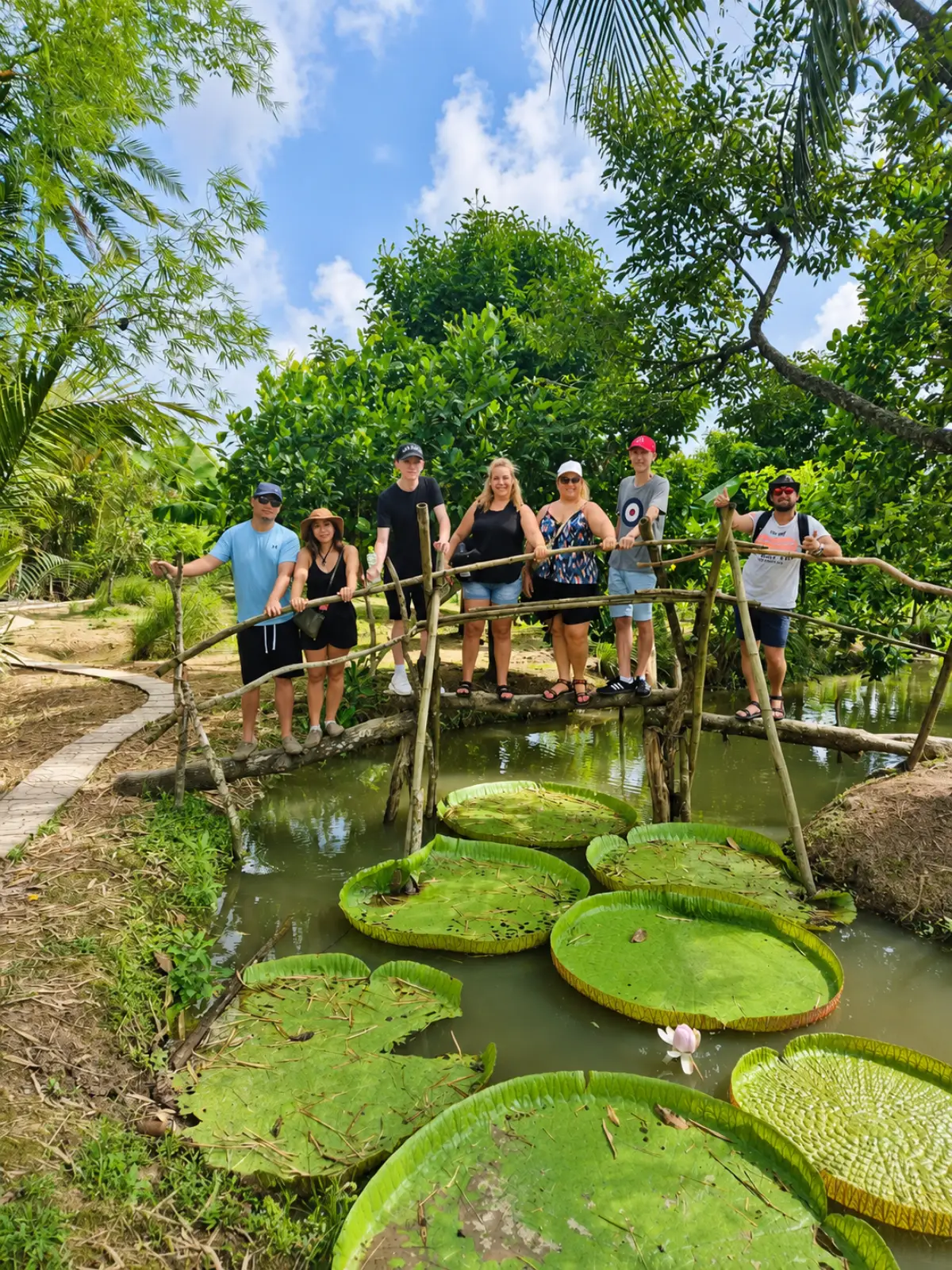 Experience the beauty of the Mekong Delta by visiting lush tropical fruit gardens filled with giant lotus leaves, peaceful canals, and local countryside charm. Travelers can explore authentic rural life, enjoy fresh tropical fruits, and capture unforgettable moments surrounded by nature in Southern Vietnam.
